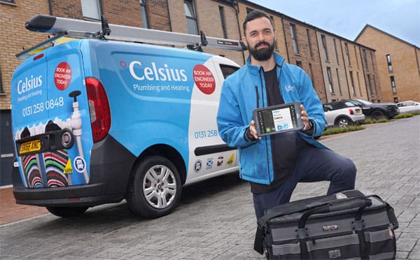 Celsius Plumbing and Heating employee holding a BigChange mobile device