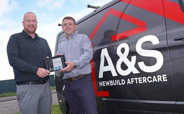 A&S employees holding BigChange tablet in front of A&S van
